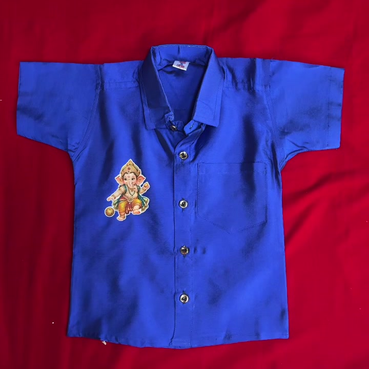 Blue kids shirt with Baby Ganesha patch applied, flat lay