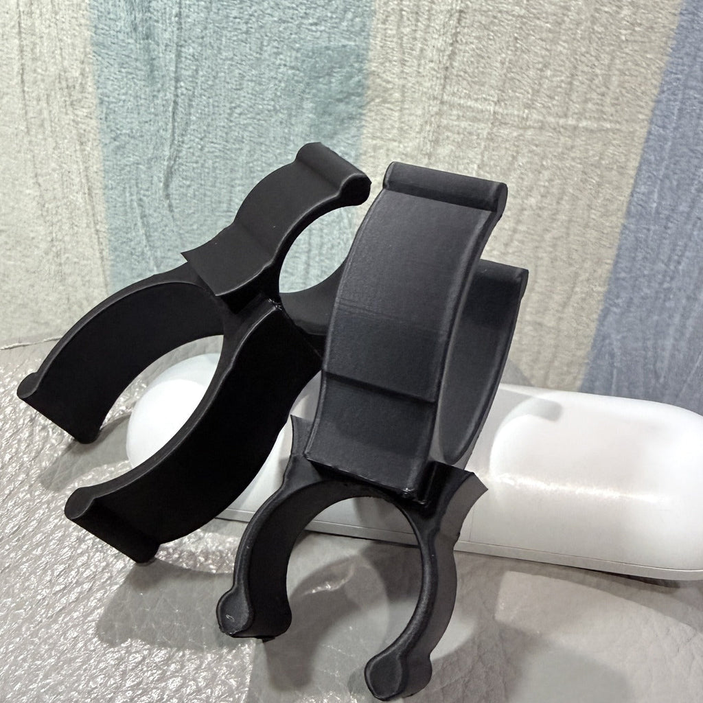 Single black 3D-printed rod holder clip, side view