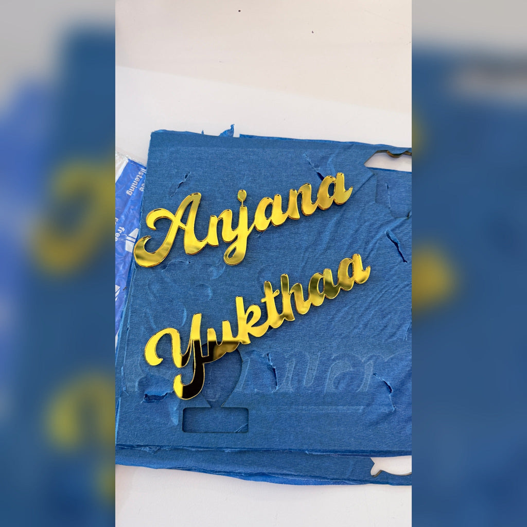 Gold mirror acrylic name cutouts in production