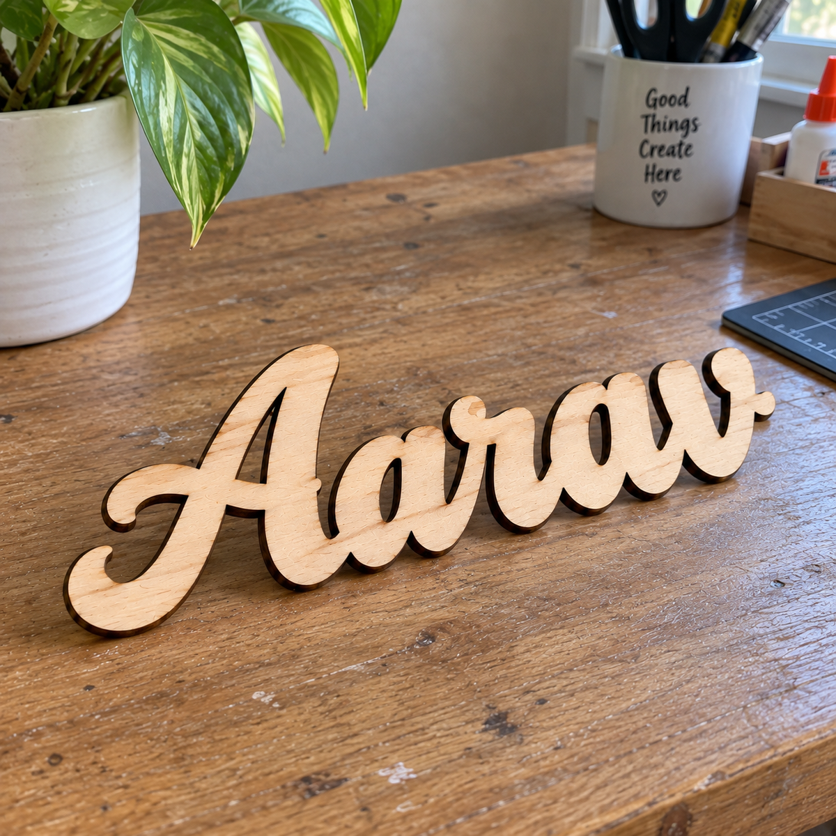 Natural wood custom name cutout on desk, personalized laser-cut wooden name sign
