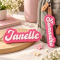 Pink personalized 3D-printed name bag tags on backpack, custom kids luggage tag
